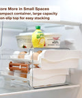 Egg Holder For Refrigerator With 40 Egg Capacity Two Tray Plastic Design Includes Time Tracker Brush And Nonslip Lid Top No Fuss To Stack And Organize Your Fridge with items inside refrigerator
