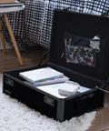 Lockable Dorm Storage Trunk With Combo Lock for Valuables, black trunk open on floor, showcasing interior compartments and items
