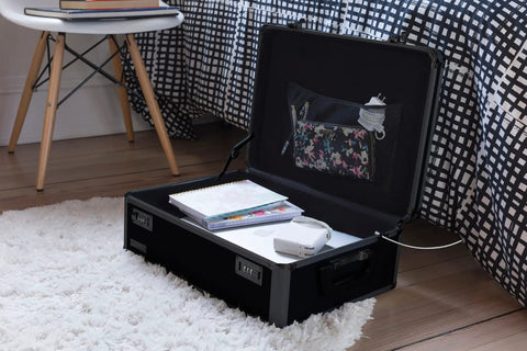 Lockable Dorm Storage Trunk With Combo Lock for Valuables, black trunk open on floor, showcasing interior compartments and items