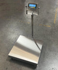 Hella Durable 20 By 20 Inch Industrial Floor Scale Platform With Digital Display And 400 Pound Capacity Ntep Certified Legal Trade Washdown Compatible Waterproof Design Internal Rechargeable Battery on a warehouse floor.