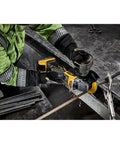Badass 20V Max Xr Brushless Cordless Angle Grinder cutting metal rebar on workbench with variable speed features.