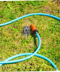 Ciieeo 3 Piece Pipe Threader Kit For Pvc Plumbing on grass with attached blue hose for DIY plumbing projects.