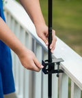 Person installing Deck Torch Mounting Bracket Kit With Four Adjustable Clamps For Rails Or Balusters, Fits Torch Poles 0.75 To 1.25 Inches