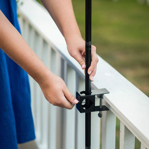 Person installing Deck Torch Mounting Bracket Kit With Four Adjustable Clamps For Rails Or Balusters, Fits Torch Poles 0.75 To 1.25 Inches