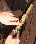 Person operating Brass Garden Hose Quick Connect Set With Shutoff Valve, Three Quarter Inch Fittings, on a deck