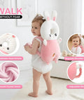 Toddler wearing pink Toddler Head Protection Backpack With Adjustable Straps, Breathable Shock Absorbing Cushion For Falls