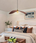 33.4" Large Wood Pendant Lights, Mid-Century Modern Natural Black Walnut Wood Pendant Light Fixture hanging over a cozy bedroom.