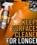Meticulous Matte Finish Detailer and Spray Sealant for Satin and Matte Surfaces Quick Detailer That Keeps the Non Gloss Look Safe on Vinyl Wraps for Cars Trucks and SUVs 16 Oz bottle held by a hand in front of a car's matte surface.