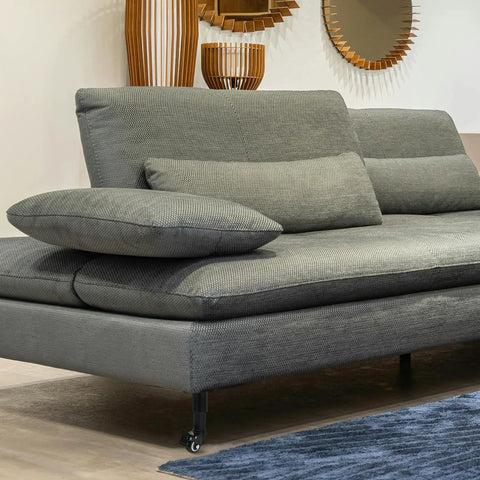 Adjustable Furniture Legs With Wheels 4 Pack No Sweat Install Heavy Duty Cold Rolled Steel visible on a gray sofa in a room.