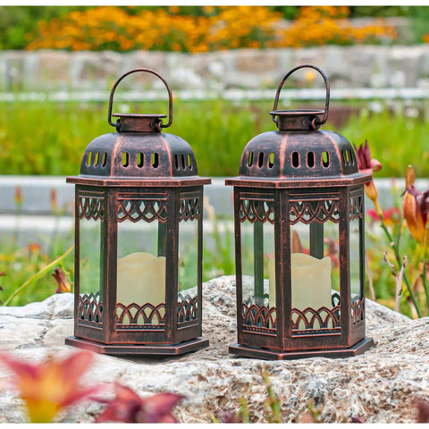 Two Pack Bronze Solar Lanterns With Ornate Retro Hanging Design, Outdoor LED Flickering Candle Lights in garden setting
