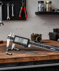 6 Inch Electronic Digital Caliper with Stainless Steel Build and Extra Large LCD Screen on workshop table with tools