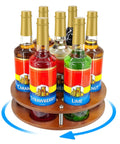 Rotate Your Home Bar Slick With This Seven Slot Coffee Syrup Organizer Rack showing seven syrup bottles in a rotating bamboo holder.