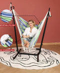 Bohemian Hammock Chair With Stand For Indoor Outdoor Relaxation, Double Swing Chair With Tassels, on round mat in room