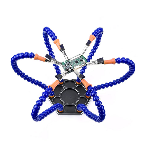 Top view of blue six-arm soldering station with rotating alligator clips holding a circuit board for electronics assembly
