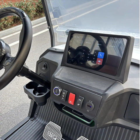 Interior view of sleek white two seater electric golf cart with touchscreen, controls, and cup holder. Kick Back In Comfort On This Sleek White Two Seater Electric Golf Cart Powered By A Dependable 48V Lithium Battery All Weather Dash Switches And Sure Grip Tires For Every Epic Course Round.