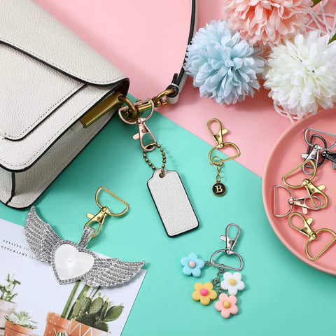 25 Heavy Duty Metal Swivel Clasp Hooks And One Inch D Ring Keychain Making Kit Featuring Smooth Lobster Claw Clasps across a purse and keychains.