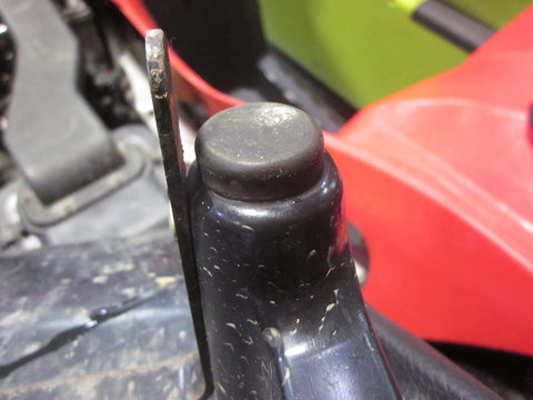 Close-up of an ATV seat mount with a rubber bumper grommet from the Seat Box and Seat Mount Rubber Bumper Grommet Set 6 Pack Replacement for ATV Seat Mounts and Cargo Boxes, Reduces Vibration and Rattles, Keeps Your Ride Tight, Restores Proper Spacing and Solid Support.