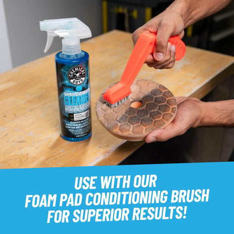 Person using brush with Foam And Wool Polishing Pad Cleaner Citrus Based 16 Oz for auto detailing on pad.