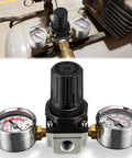 Air Regulator With 0 To 200 Psi Gauge And Four Port Adjustable Regulator, Fits Craftsman DeWalt DeVilbiss Air Compressors, Inlet And Outlet One Quarter NPT, Gauge Port One Eighth NPT, Replacement Kit With Two Gauges displayed on an air compressor
