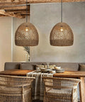 WALMHEIM 15.7" Boho Rattan Pendant Light Fixture, 1-Light Hand Woven Rustic Chandeliers over a dining table.