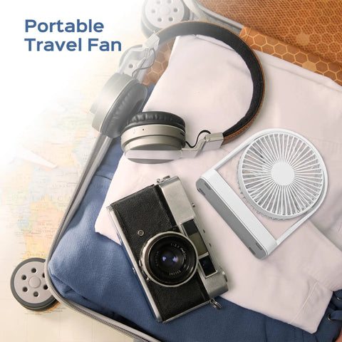 Suitcase interior with Magnetic Cruise Ship Desk Fan USB C Powered Portable With Strong Magnetic Base 3 Speed Quiet Operation Adjustable 140 Degree Tilt Ideal For Cruises Office Home Travel, headphones, and camera.