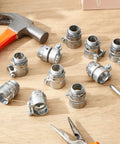 10-Pack Of Top-Shelf 1/2-Inch Squeeze Connectors For FMC And EMT Conduit Wiring arranged on a workbench with tools.