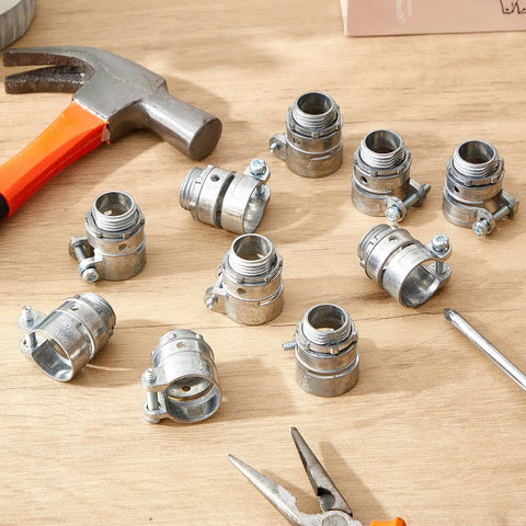10-Pack Of Top-Shelf 1/2-Inch Squeeze Connectors For FMC And EMT Conduit Wiring arranged on a workbench with tools.