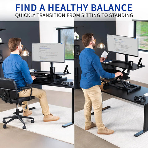 Man using 36 Inch Electric Desk Converter For Sit To Stand Dual Monitor And Laptop Workstation With Wide Keyboard Tray