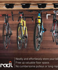 Three bicycles mounted on a ceiling with a Two Pack 40 Pound Ceiling Mount Bike Lift And Rack For No Fuss Bicycle Storage Without Electricity Ropes Or Pulleys With Internal Spring Hoist For Ceiling Hanging And Safe Convenient Bike Parking system.