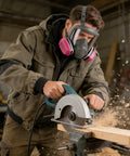 Worker using circular saw while wearing All Day Comfort Full Face Respirator Mask With Reusable Dual Filter System For Heavy Dust, Gas, And Vapor Protection