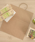 Large Kraft Paper Gift Bags With Handles 100 Pack Brown Eco Friendly Grocery Shopping Retail Takeout Bags Durable Loop Handles shown with takeout items
