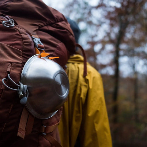 Stainless Steel Camping Mess Kit With Flexible Straps Space Saving Dish Set on a backpack, suitable for hiking and camping