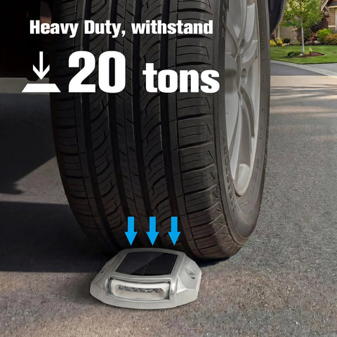 Car tire driving over a 12 Pack Solar LED Driveway Lights Two Color Options White Or Blue For Driveway Sidewalk Pathway Waterproof Outdoor Lighting