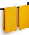 Matte Black 24 Inch Wall Mounted Towel Rack With Rustproof Aluminum Construction holding yellow towels
