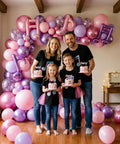 Family holding cakes in front of Pink And Purple Music Note Foil Balloons Set, 12 Inch Metallic Balloons Mix for celebrations.