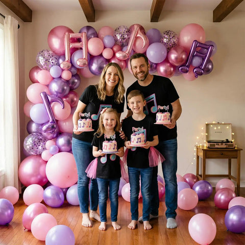 Family holding cakes in front of Pink And Purple Music Note Foil Balloons Set, 12 Inch Metallic Balloons Mix for celebrations.