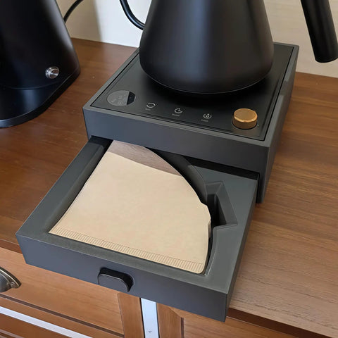Game Changing Two In One Coffee Station Organizer With Heavy Duty Kettle Stand And V60 Paper Filter Bin showing a V60 filter bin drawer with papers on a countertop.