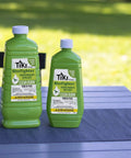 Two bottles of Clean Burn Mosquito Repellent Torch Fuel For Outdoor Use Easy Pour One Quarter Gallon 32 Oz on a patio table