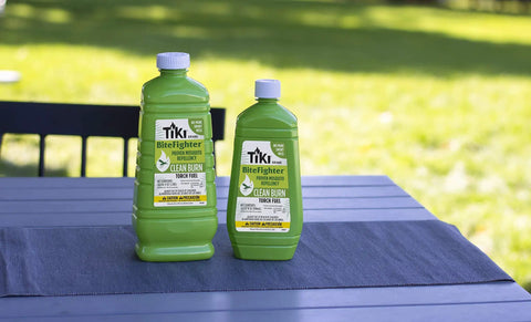 Two bottles of Clean Burn Mosquito Repellent Torch Fuel For Outdoor Use Easy Pour One Quarter Gallon 32 Oz on a patio table