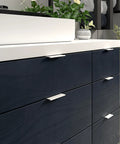 Lincoln Collection 3 1/8 Inch Center to Center White Modern Cabinet and Drawer Edge Pull Handle installed on dark cabinetry