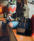 Flower Shape Pink Himalayan Salt Lamp with wood base on table near person with backpack in cozy setting.