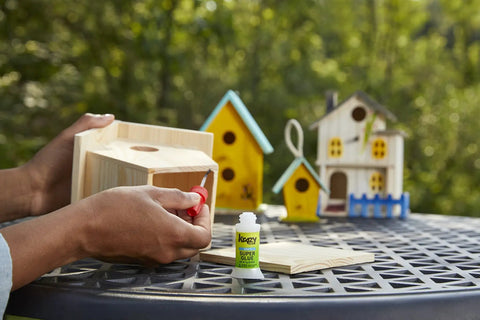 Multipurpose Brush On Super Glue Six Count Pack Quick Drying Liquid Adhesive Zero Hassle Applicator used on wooden birdhouse.