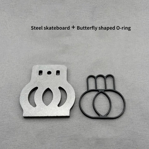 Steel skateboard insert and butterfly shaped O-ring on grey background