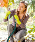 Woman using 2 Pack 5.7 Inch Garden Hose Extension Adapters with Coil Spring Protectors in a garden setting.