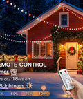 Pastel Globe USB String Lights 33Ft With 100 LEDs Easy Timer And Remote Indoor Outdoor Party Decor For Easter Dorm Rooms Classrooms Patio Garden Trees And Spring Vibes lighting up snow-covered house at night with remote control in hand.