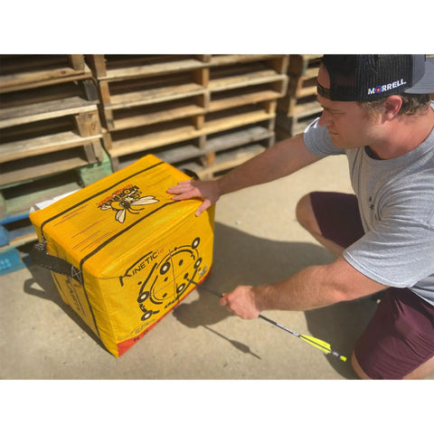 Person using Yellow Jacket Kinetic One Point Zero 65 Pound Portable Field Point Archery Target Bag With Two Sides Ten Bullseyes And Weather Resistant Durable Handles For Outdoor Practice And Training