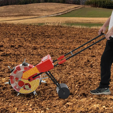 Person using Metal Garden Push Seeder With Seven Seed Holes, No-Bend Labor-Saving Walk-Behind Planter for Row Crops in a field