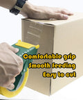Heavy Duty Ergonomic Packing Tape Gun Dispenser Adjustable 2 Inch Box Sealer being used on a cardboard box with a comfortable grip.