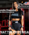 Fitness model posing in gym with Schiek fitness gear and branded equipment.