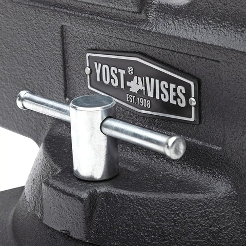 Heavy Duty 5 And A Half Inch Mechanics Work Bench Vise With Secure Grip Swivel Base For Woodworking And Metalworking Featuring 60,000 PSI Cast Iron Construction And Extra Large Anvil Surface Built Like A Tank For Pro Grade Projects close-up handle and YOST badge